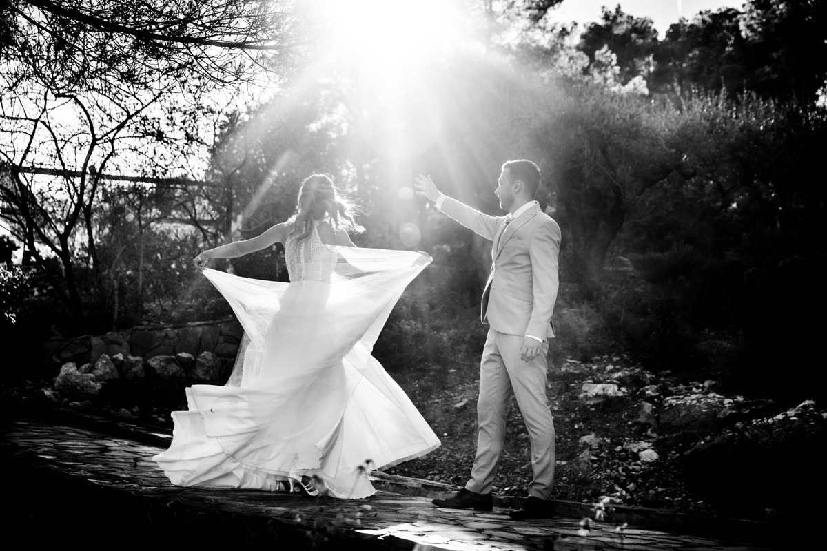 Ola and Akis dancing together on their wedding day, black and white