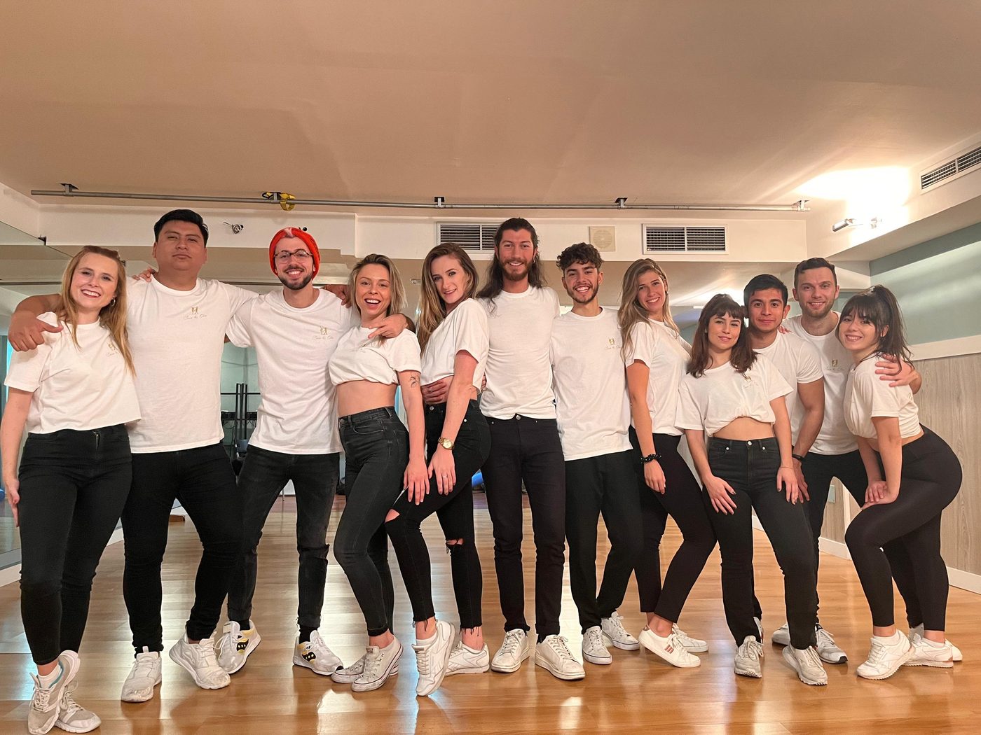 A group dance class posing together after a session in the studio